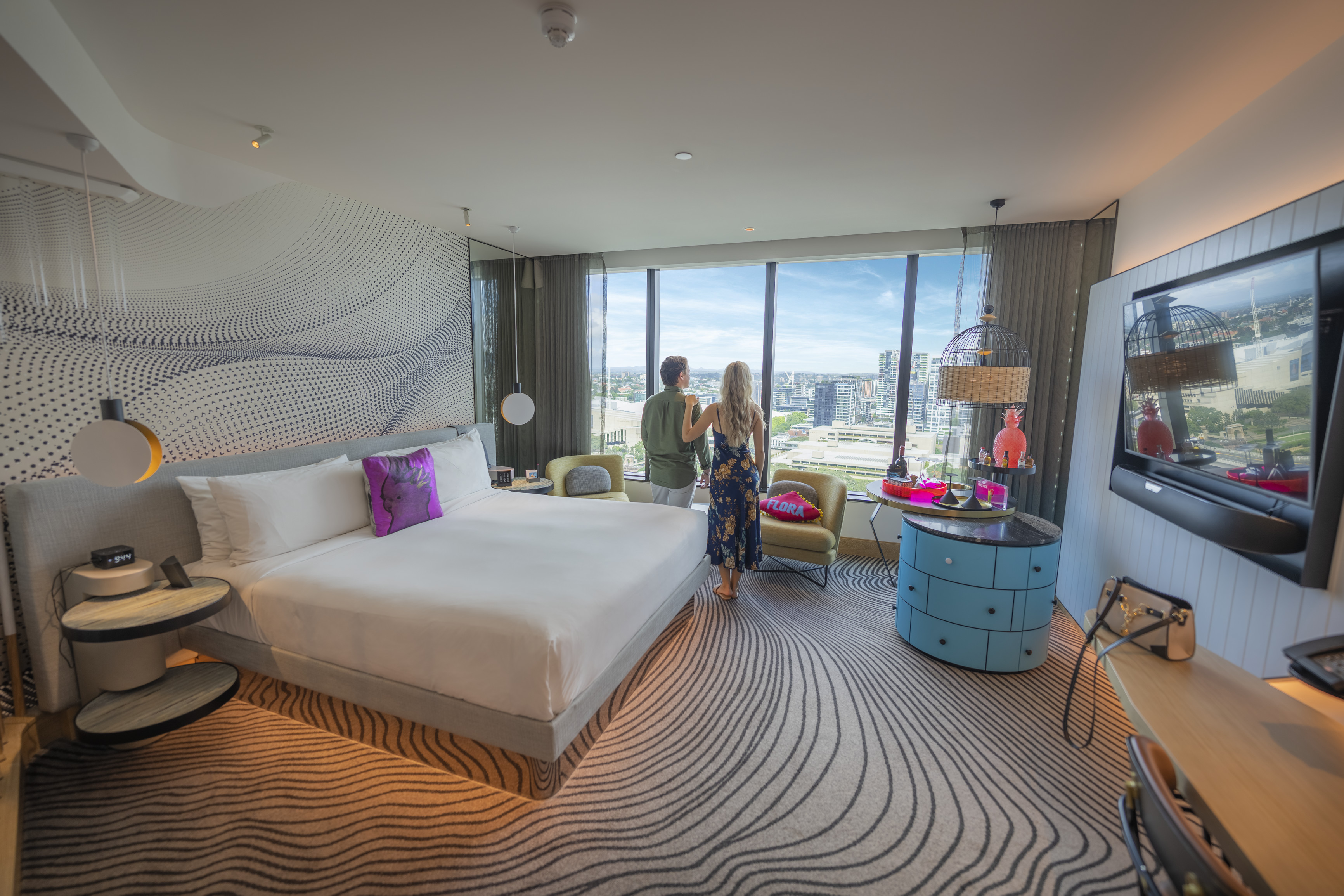Couple looking out of their room at the W Brisbane