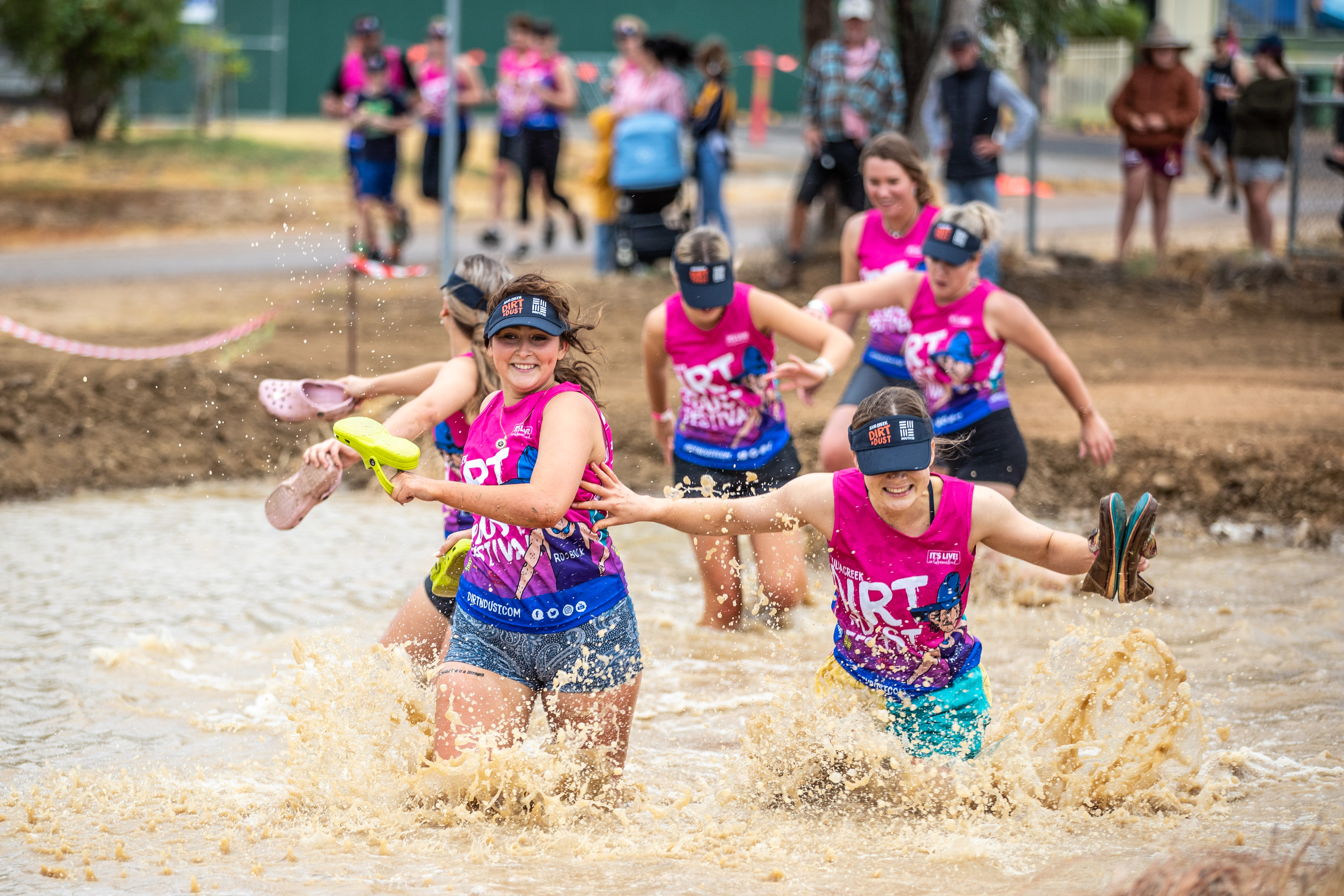 Competitors run through deep muddy waters during the Adventure Run at Julia Creek Dirt n Dust Festival 